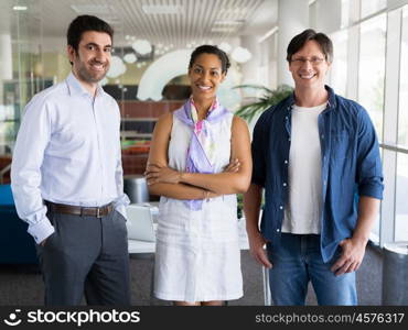 Three collegues standing next to each other in an office