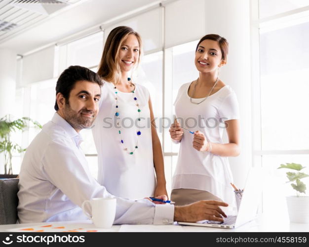 Three collegues working together in an office