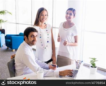 Three collegues working together in an office