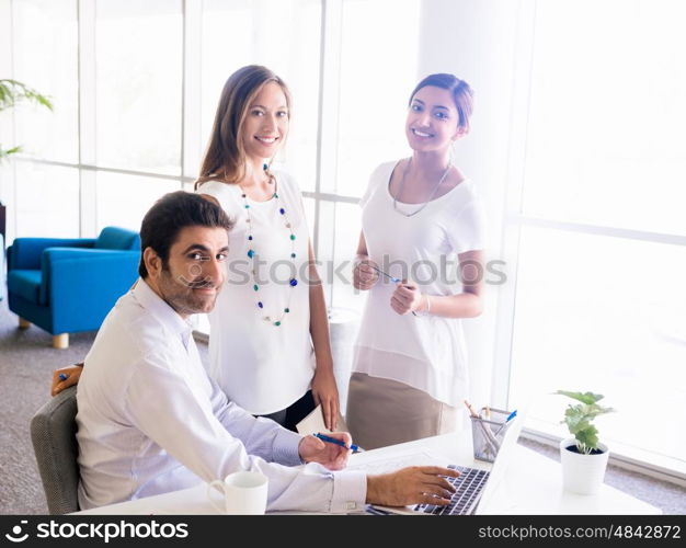 Three collegues working together in an office