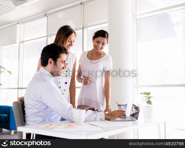 Three collegues working together in an office