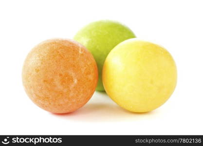 three color chewing gum balls on white background