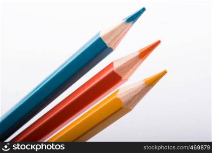 Three Color Pencils on a white background