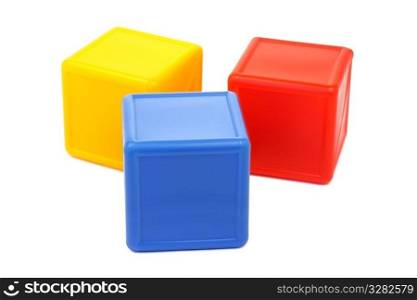 Three colored childrens cubes on a white background