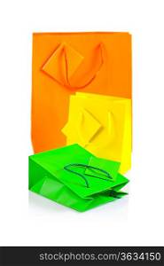 three colored paper bags isolated