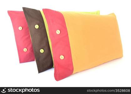 three colored pillows with buttons isolated on white