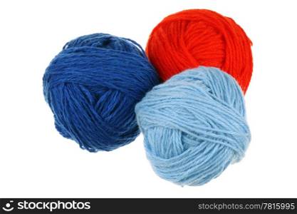 Three colored woolen balls on a white background