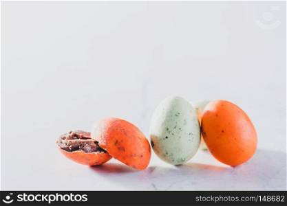 Three colorful eggs on a light background. Easter eggs. Chocolate candies. Copyspace.. Three colorful eggs on a light background.