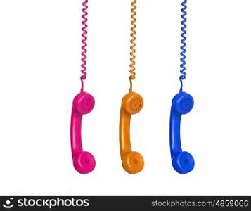 Three colorful phones hanging from a cable isolated on a white background