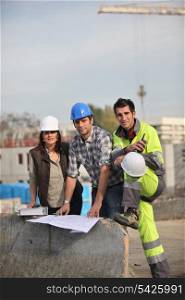 Three construction workers sharing their ideas