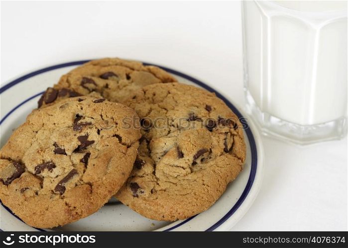Three cookies and a glass of milk