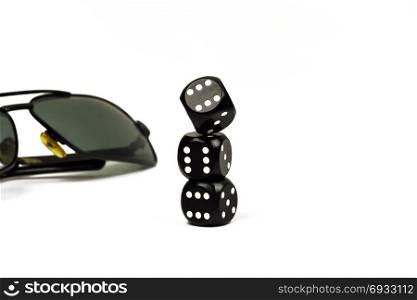 Three cube for poker close-up and sunglasses on white background