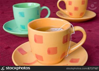 three cups of tea on the table