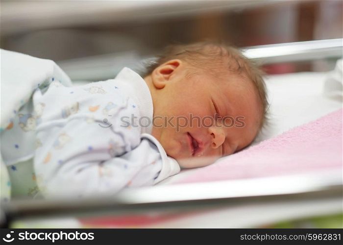 Three days old newborn baby in bed