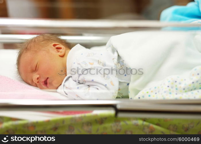 Three days old newborn baby in bed