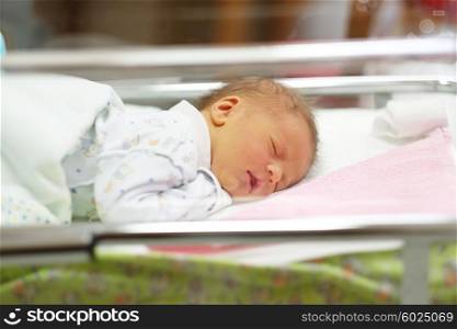 Three days old newborn baby in bed