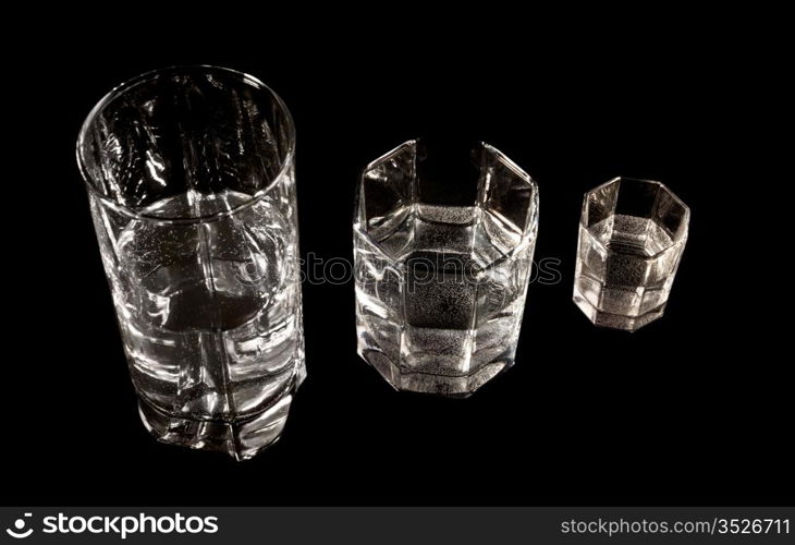 three different glasses on black background