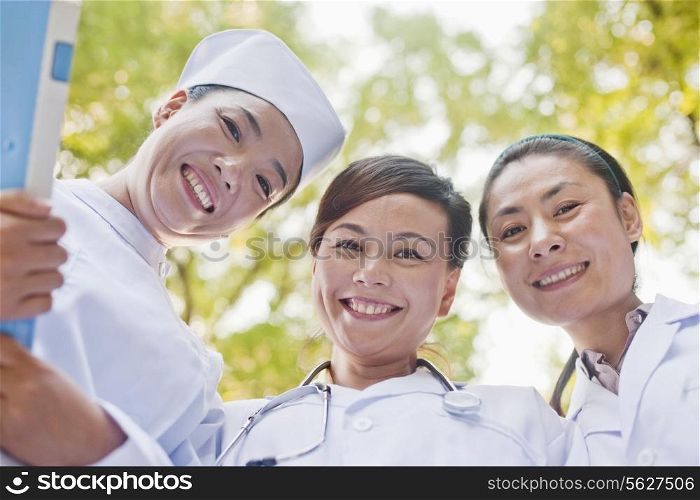 Three Doctors Looking Down at Camera