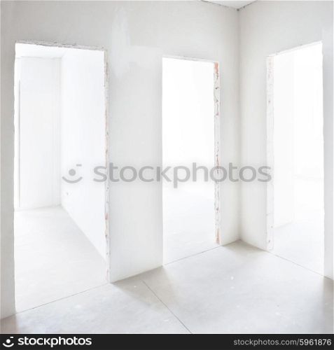 Three doors in white room. Empty interior