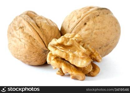three dried walnuts on a white background