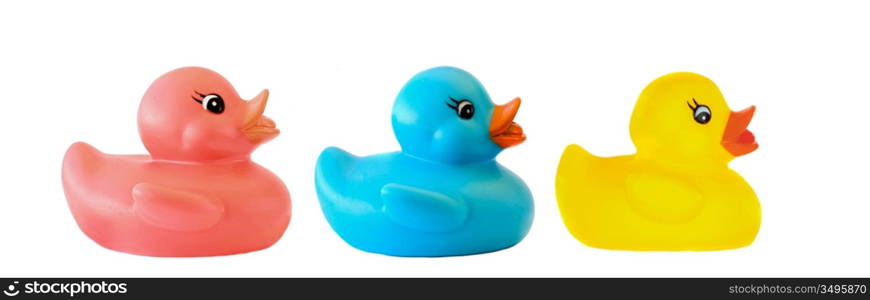 Three ducks toy of different colors on a over white background