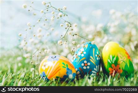 Three Easter eggs on green grass. Spring holiday, Christian tradition, symbol of life.. Three Easter eggs on green grass.