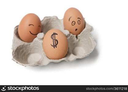 Three eggs in carton with a dollar sign on one egg