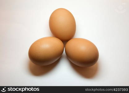 Three eggs positioned in a triangular shape isolated on white