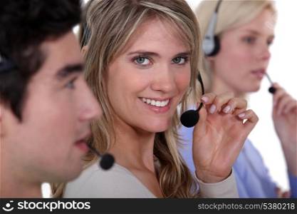 three employees holding headsets