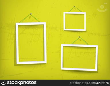 Three empty frame of picture on the yellow old wall. Eps10. Used opacity layers for effect of shadows