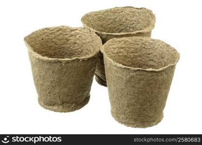 Three empty peat pots over white background
