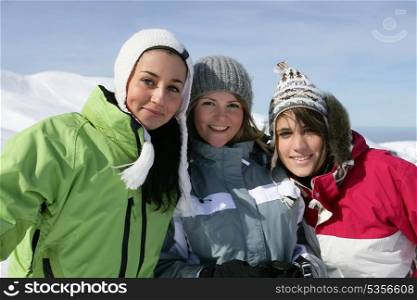 Three female friends skiing