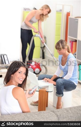 Three female housemates cleaning