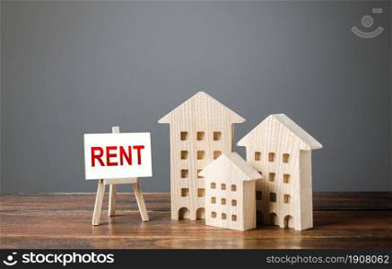 Three figures of houses and an easel with the word rent. Realtor services, search for optimal options. The concept of temporary rental housing and real estate. The choice between renting and buying.