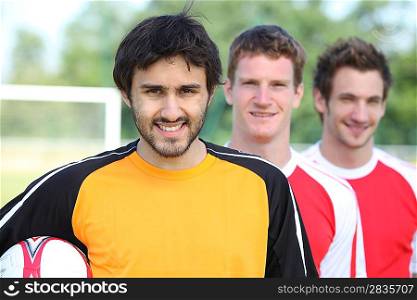 Three football players