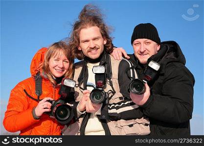 three fotographers against blue sky 2
