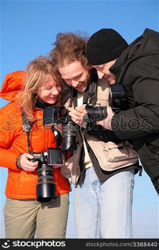 three fotographers against blue sky 3