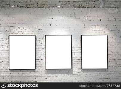 three frames on brick wall