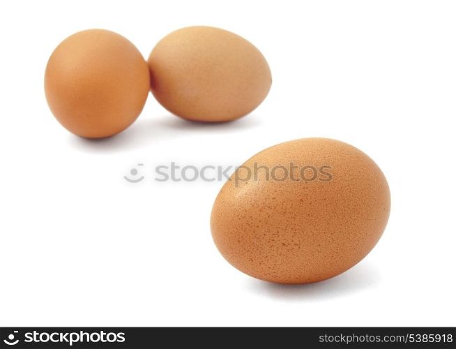 Three fresh brown eggs isolated on white