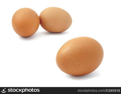 Three fresh brown eggs isolated on white