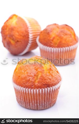 Three fresh muffins isolated on white background