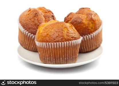 Three fresh muffins on plate isolated