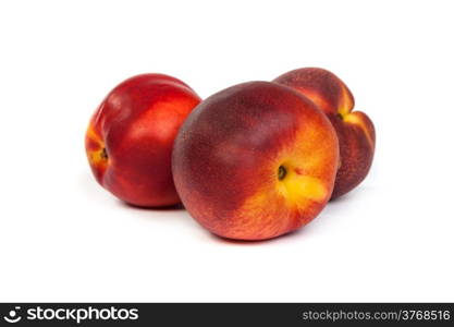 Three fresh nectarines isolated on a white background