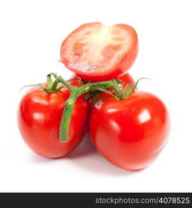 three fresh tomatoes with green leaves isolated on white background