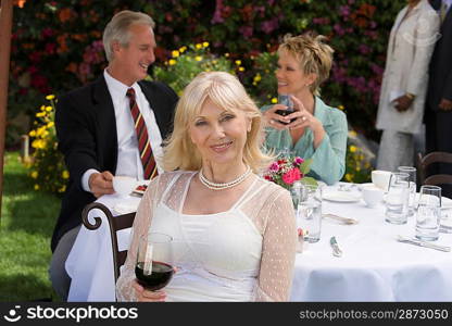 Three friends drinking wine outdoors