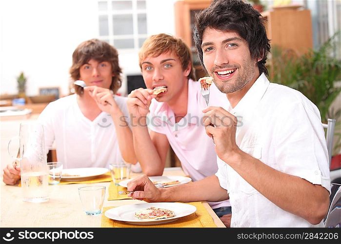 Three friends enjoying outdoor meal together