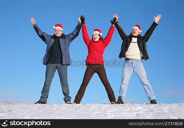 three friends greetings on snow in santa claus hats
