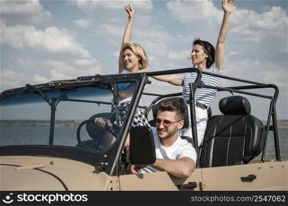three friends having fun traveling by car