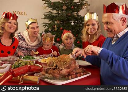 Three Generation Family Enjoying Christmas Meal At Home