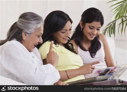 Three generation family looking at photo album